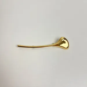 Gold minimalist leaf brooch for women, sleek alloy suit pin, elegant fashion jewelry accessory.