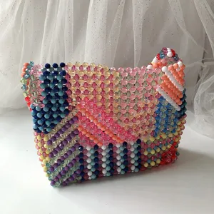 Détail du sac à main en perles colorées, mettant en valeur le travail artisanal et le motif patchwork.