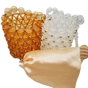 Handmade beaded bucket bag set with satin inner pouch and clear amber acrylic beads.