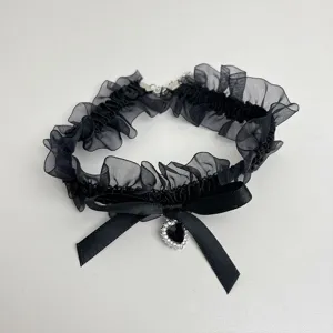Black sheer mesh lace choker necklace featuring a sweet bow and crystal heart pendant detail.