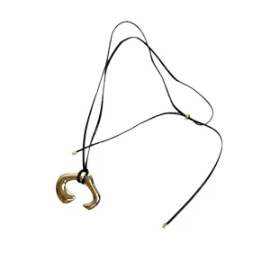 Elegant U-shaped metal pendant necklace with leather cord for women fashion style.