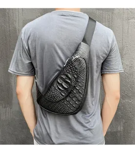 Detail shot of men's genuine leather chest bag with crocodile pattern and adjustable strap.