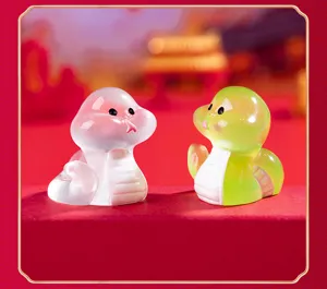Mini luminous snake figurine macro detail, cute translucent zodiac toy accessory for DIY decor.