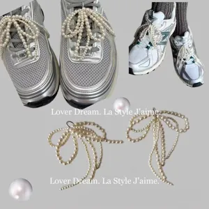 Pearl bow shoe clip detail, elegant accessory for sneakers, high-end fashion footwear charm.