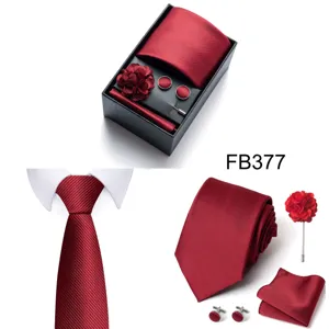 Red men's tie set with gift box, pocket square, cufflinks, lapel flower, and tie clip.