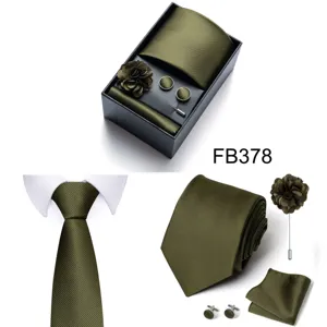 Detailed view of men's olive green striped tie, pocket square, cufflinks, and gift box.