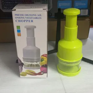 Hand-pressed vegetable chopper in green, ideal for quickly cutting garlic, onions, and kitchen veggies.