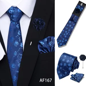 Blue jacquard tie set featuring pointed tie, pocket square, and lapel flower for men.
