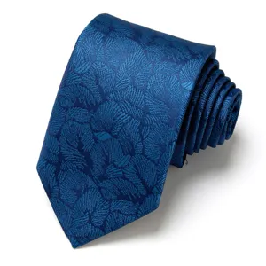 Detailed shot of a stylish blue jacquard tie with elegant leaf pattern and rolled design.