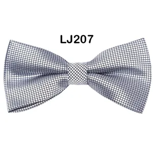 Silver grid bow tie detail showing the exquisite geometric jacquard texture and premium fabric.
