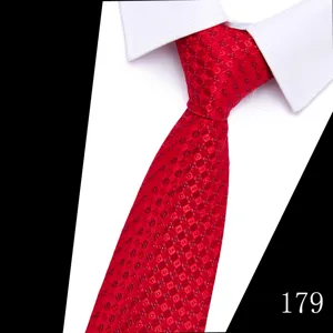 Close-up detail of red jacquard polka dot tie paired with a crisp white shirt collar.