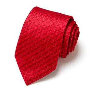 Detail shot of red jacquard pattern men's business tie rolled up nicely for formal wear.