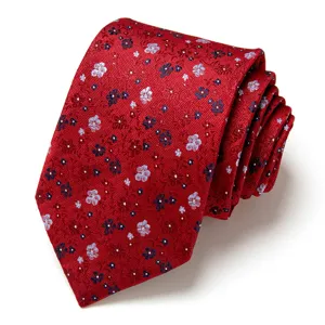 Red men's necktie with delicate floral jacquard pattern, elegant formal accessory for wedding.