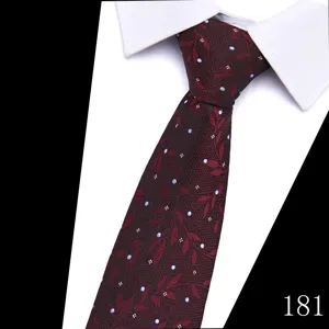 Close-up of a dark red tie with delicate leaf pattern and blue dots, paired with white collar.
