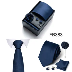 Men's dark blue woven tie pocket square cufflinks lapel flower gift box accessory detail view.