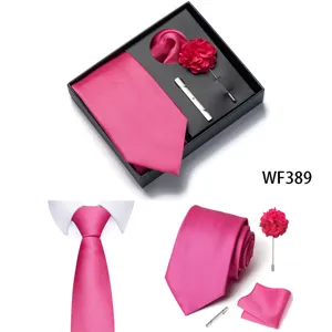 Vista dettagliata set cravatta rosa uomo, con pochette, fiore da risvolto e fermacravatta.