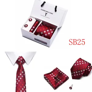 Detailed view of the red polka dot tie, pocket square and cufflinks set in a gift box.