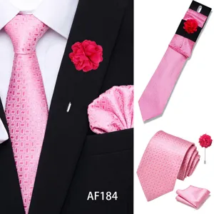 Detail shot of men pink jacquard tie set featuring pointed tie, pocket square, and brooch.