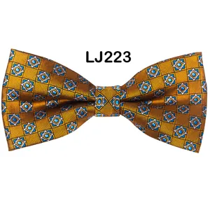 Detail view of a stylish yellow patterned men's bow tie with blue star jacquard for weddings.