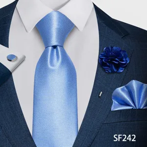 Vista detallada de un conjunto de corbata azul texturizada con pañuelo, flor y gemelos.
