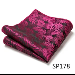 Detailed close-up of a men's magenta and black leaf patterned pocket square accessory.