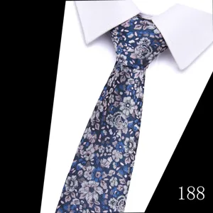 Detailed close-up of men's floral jacquard tie in blue and pink tones, fine texture.