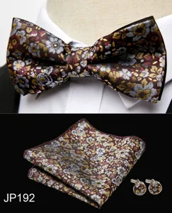 Close-up detail of men vintage floral jacquard bow tie, pocket square and cufflink set.