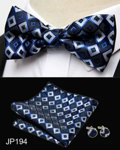 Detail shot of blue and black geometric diamond pattern bow tie set with pocket square and cufflinks.