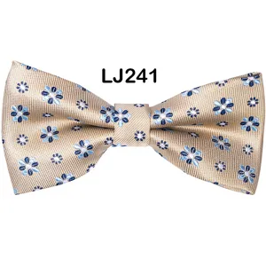 Men's gold floral jacquard bow tie detail view, elegant wedding party tuxedo accessory.