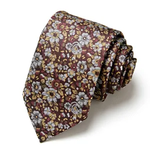 Men's floral jacquard tie detail showing intricate flower pattern and fine fabric texture.