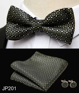 Detailed view of mens black gold jacquard bowtie, pocket square and cufflink accessory set.