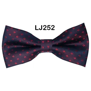 Men's navy blue bow tie with red star jacquard pattern, ideal for weddings and business events.