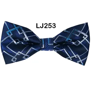 Close-up detail of the blue geometric jacquard fabric and clean stitching on the stylish bow tie.