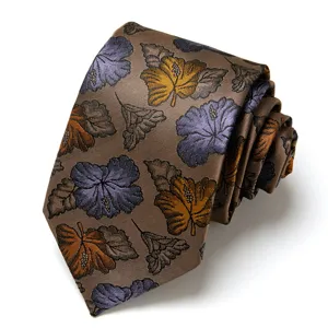 Close-up detail of brown men's jacquard tie featuring elegant blue and yellow floral pattern.
