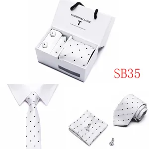 Detail shot of white polka dot tie, pocket square and cufflinks gift set, elegant design.
