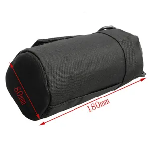 Black tactical pouch detail showing cylindrical design, compact size, and durable fabric.