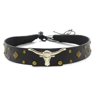 Close up view of the black leather hat band featuring a metallic silver bull head and studs.