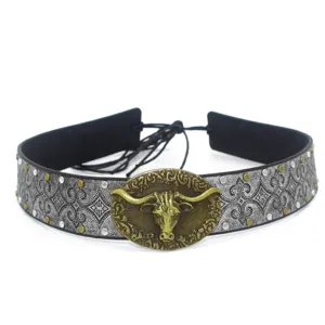 Vintage bull head hat band detailed close-up, retro metallic embossed cowboy hat accessory style.