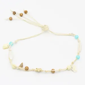 Exquisite boho style woven hat band detail featuring natural shells and wooden beads.