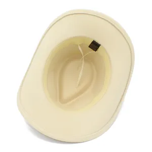 Interior detail view of a beige western cowboy hat showing comfortable inner lining and fabric tag.