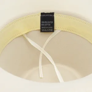 Beige felt hat inner detail with composition label showing 35% polyester 65% cotton.