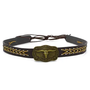 Detail view of vintage western cowboy hat band with bull skull buckle and braided stitching.