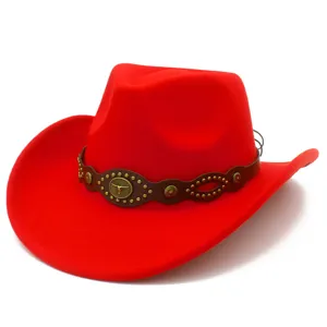 Close-up red cowboy hat detail featuring brown leather band, metallic studs and bull head.