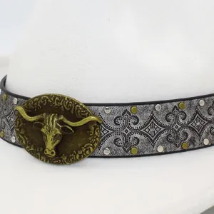 Detail shot of stylish cowboy hat with retro bull head metal buckle and ethnic band.