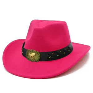Pink cowboy hat detail closeup showing gold horse buckle and metal studs on black belt.