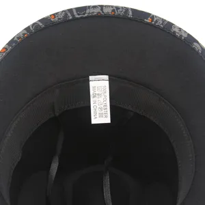 Detailed interior view of a Halloween jazz top hat with skull pattern lining and wash label.