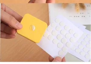 Transparent round double sided glue dots detail view showing easy peeling and application.