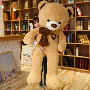 Giant plush teddy bear with big bow and heart embroidery, perfect cute gift for girls and kids.