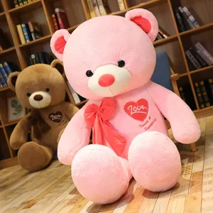 Large pink teddy bear plush toy with big bowknot and heart love embroidery, cute gift.