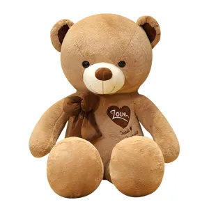 Large brown teddy bear plush toy with love heart and bowknot, soft huggable stuffed doll gift.